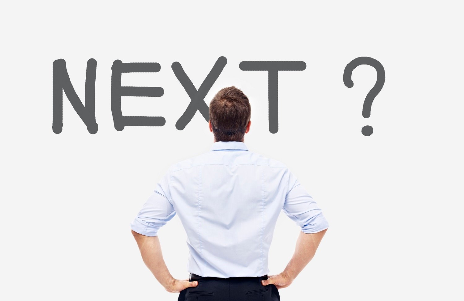 Man standing in front of a wall with NEXT printed on it