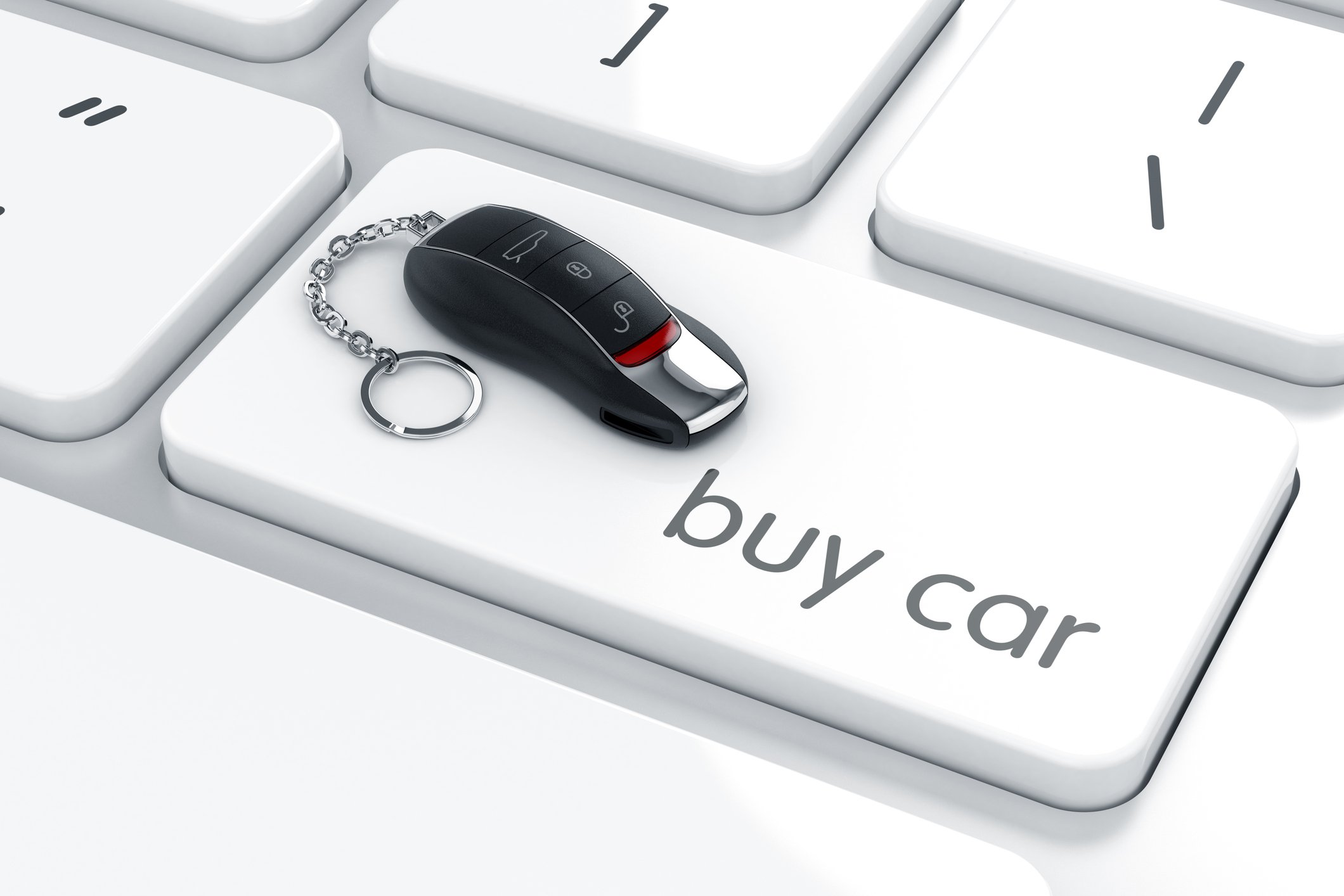 Car keychain on a computer keyboard key labeled "Buy Car."