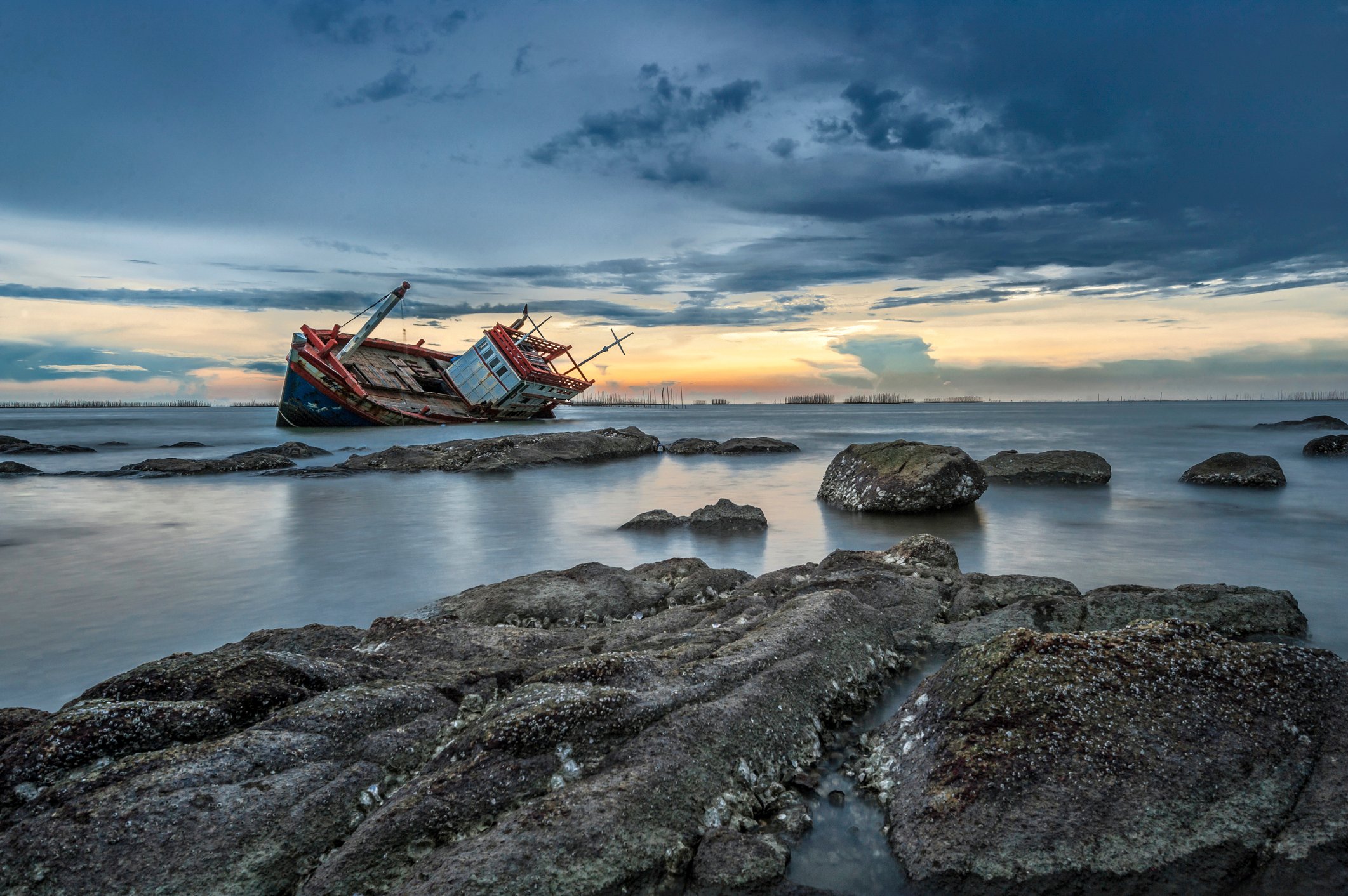 Cargo ship on rocks.