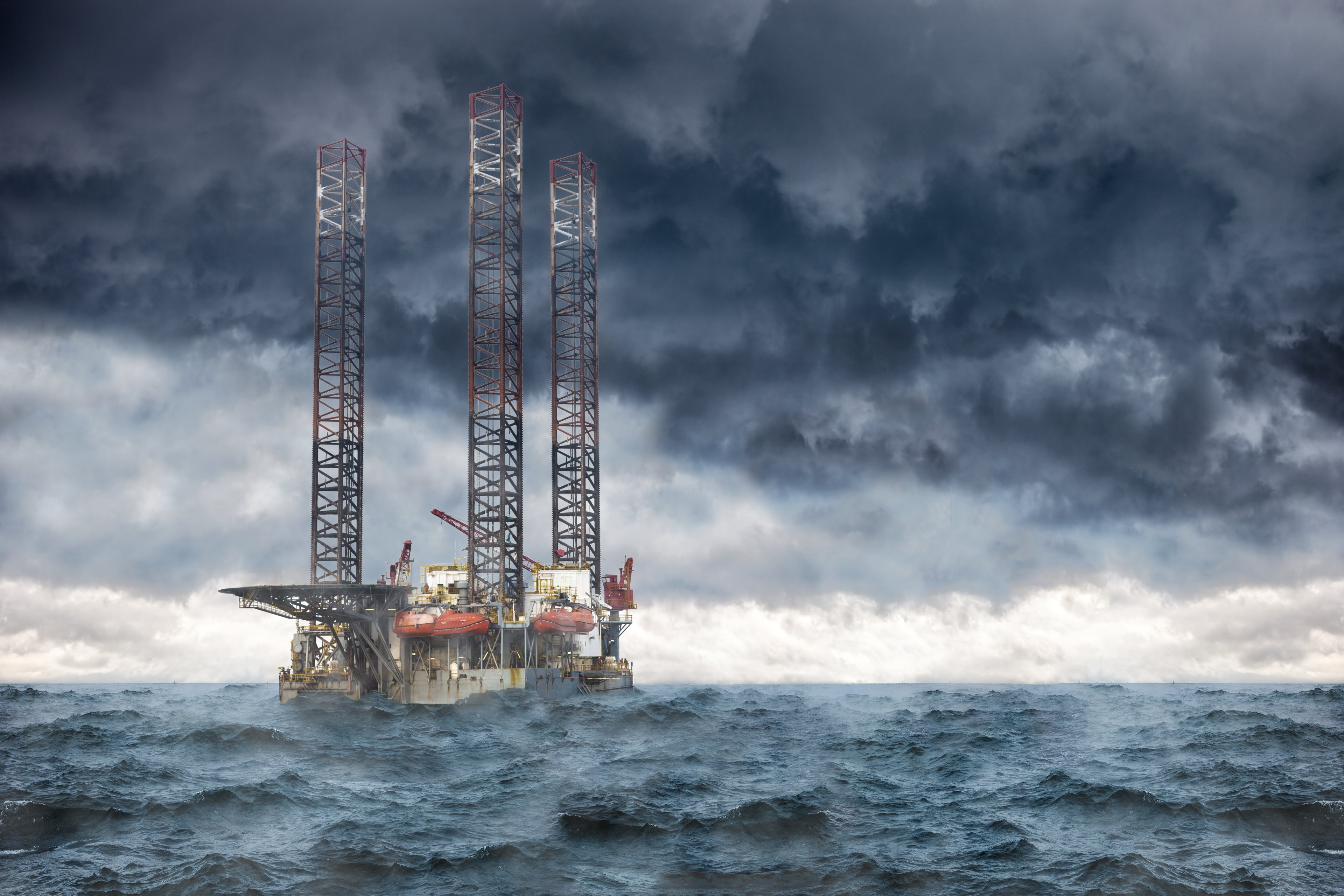 Offshore oil rig under a stormy sky.