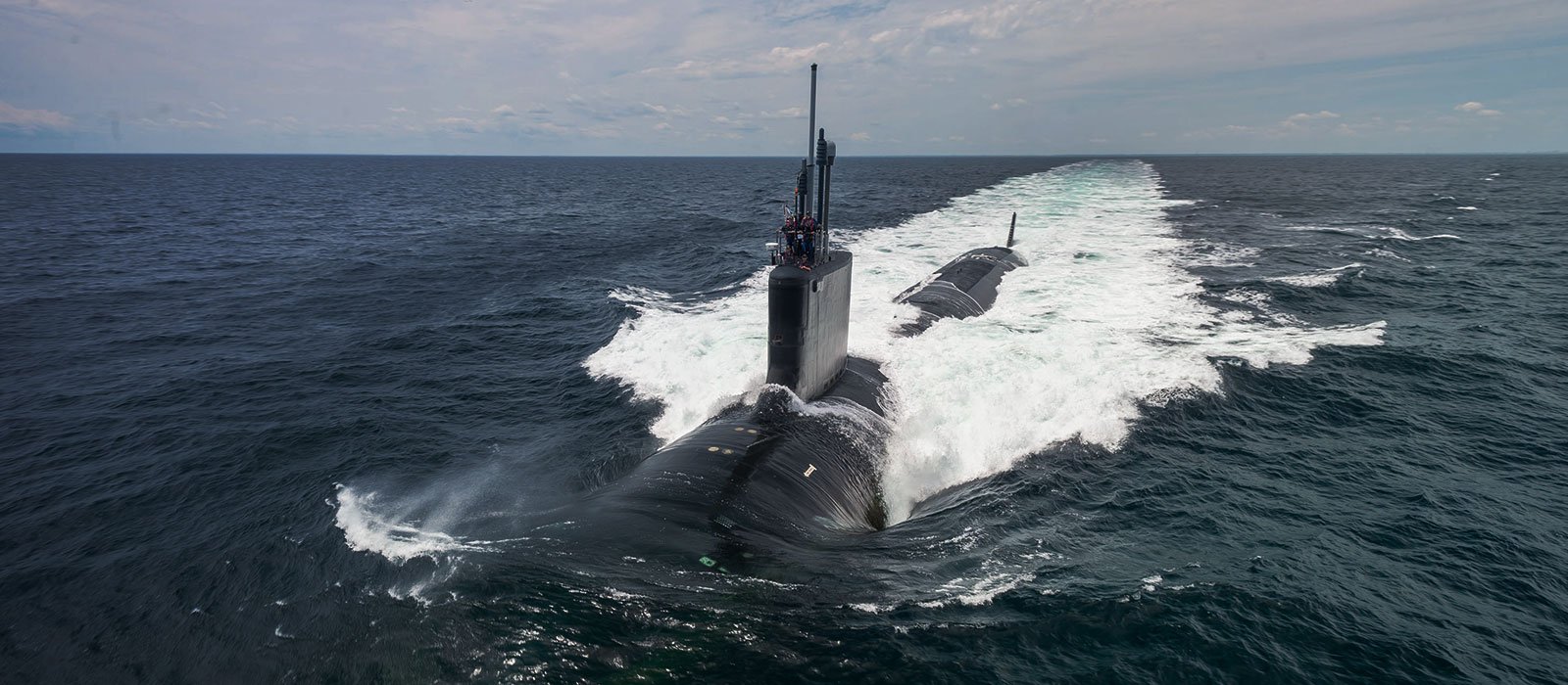 Submarine USS John Warner (SSN 785) half-submerged in the ocean