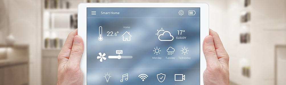 Two hands hold out a tablet, with a weather app on the screen.