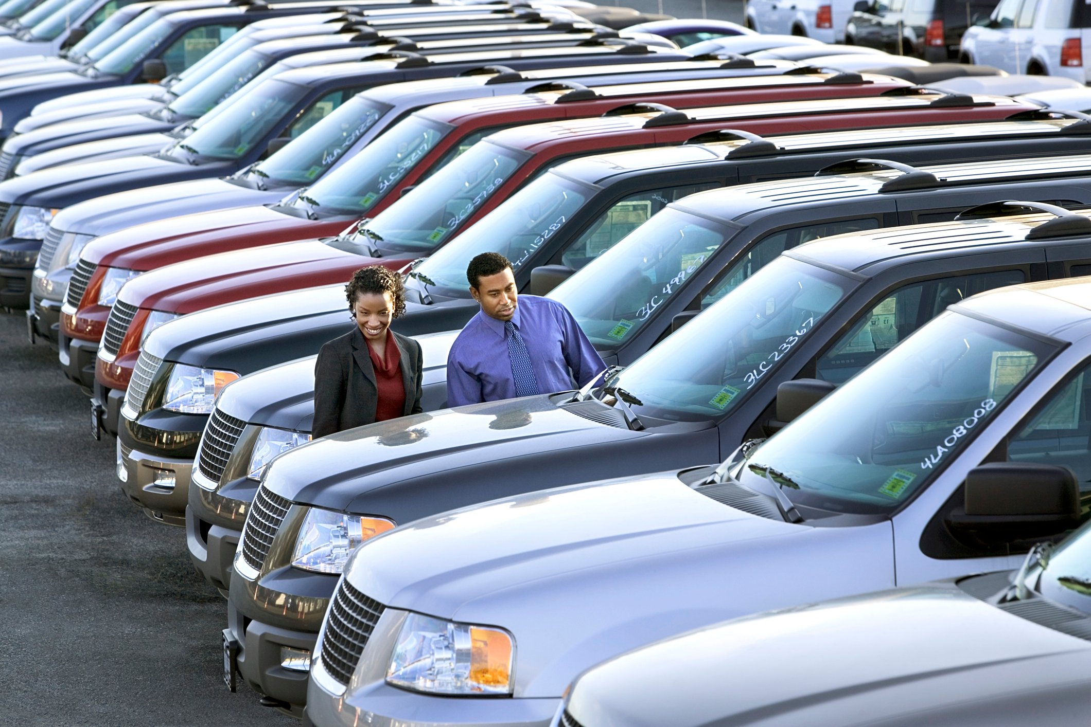 Couple shopping for an SUV at dealership.