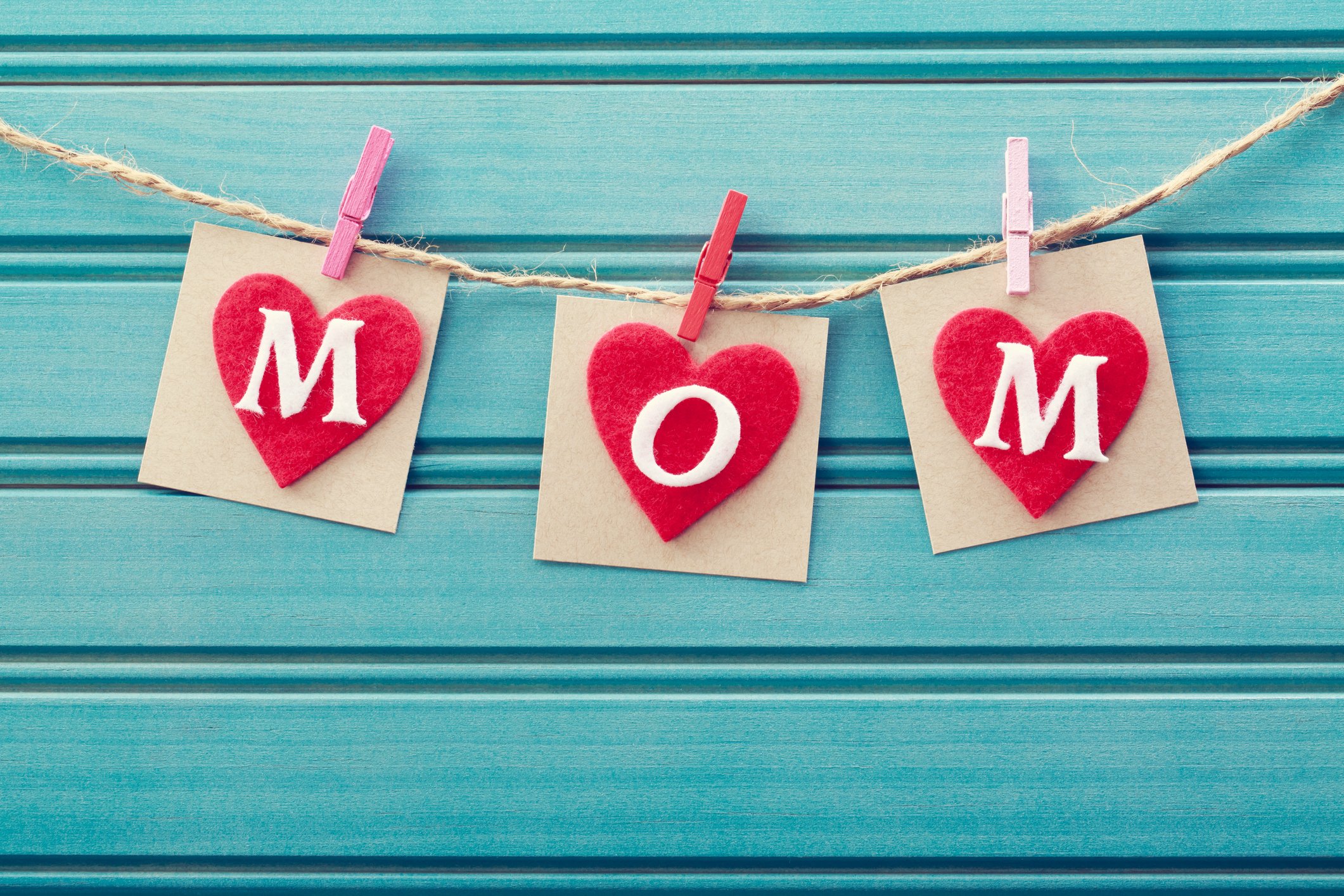 3 cards spelling "Mom" inside hearts