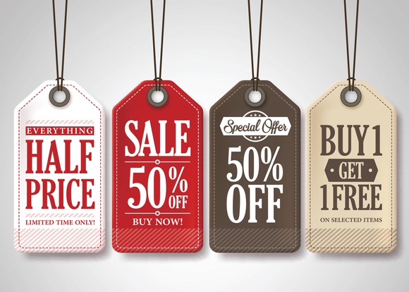 A group of multi-colored sales tags reading 50% off, half off, and buy-one-get-one-free.