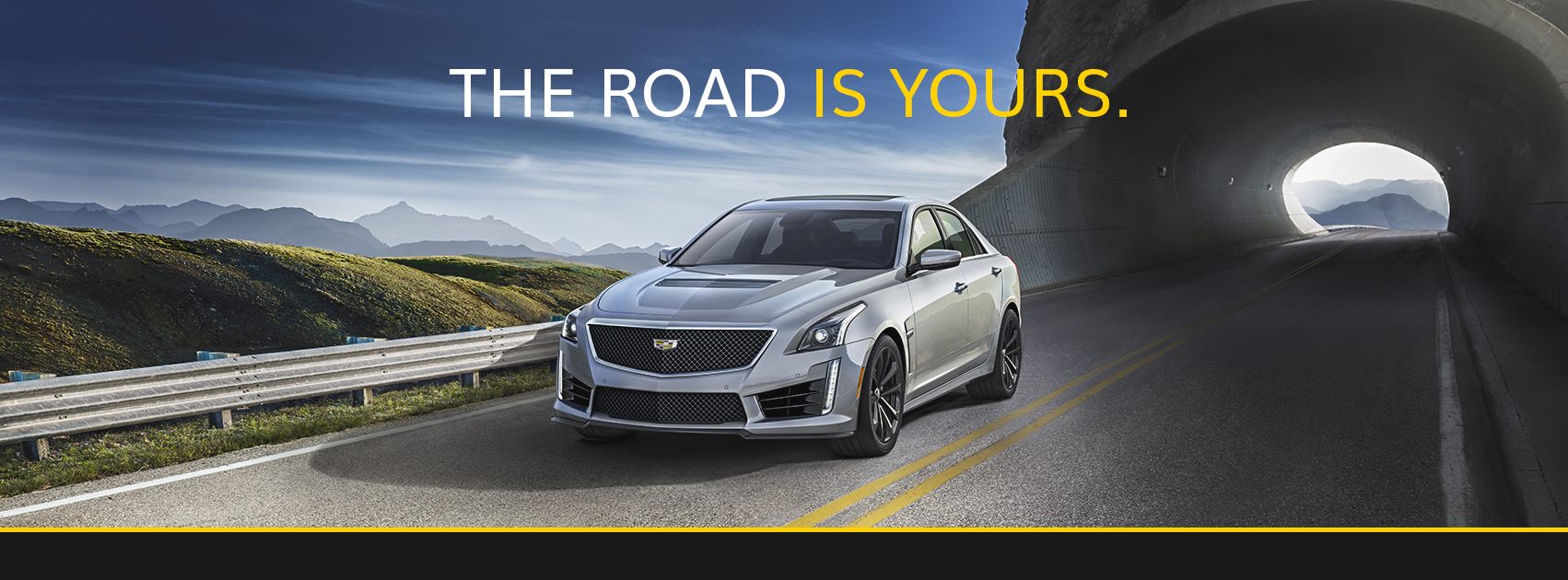 Car driving with text above the car reading, "The road is yours"