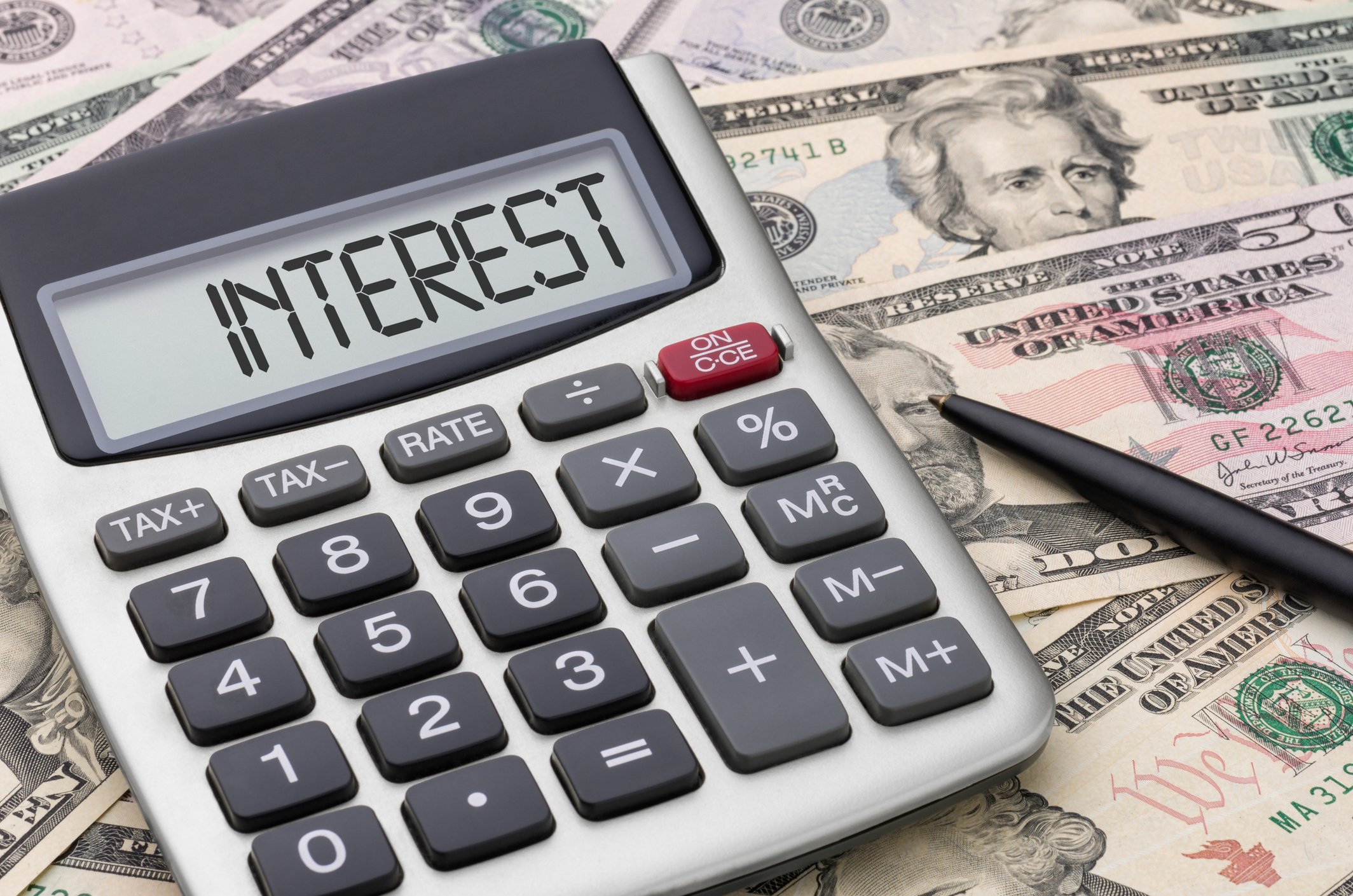 Interest calculator on a pile of money