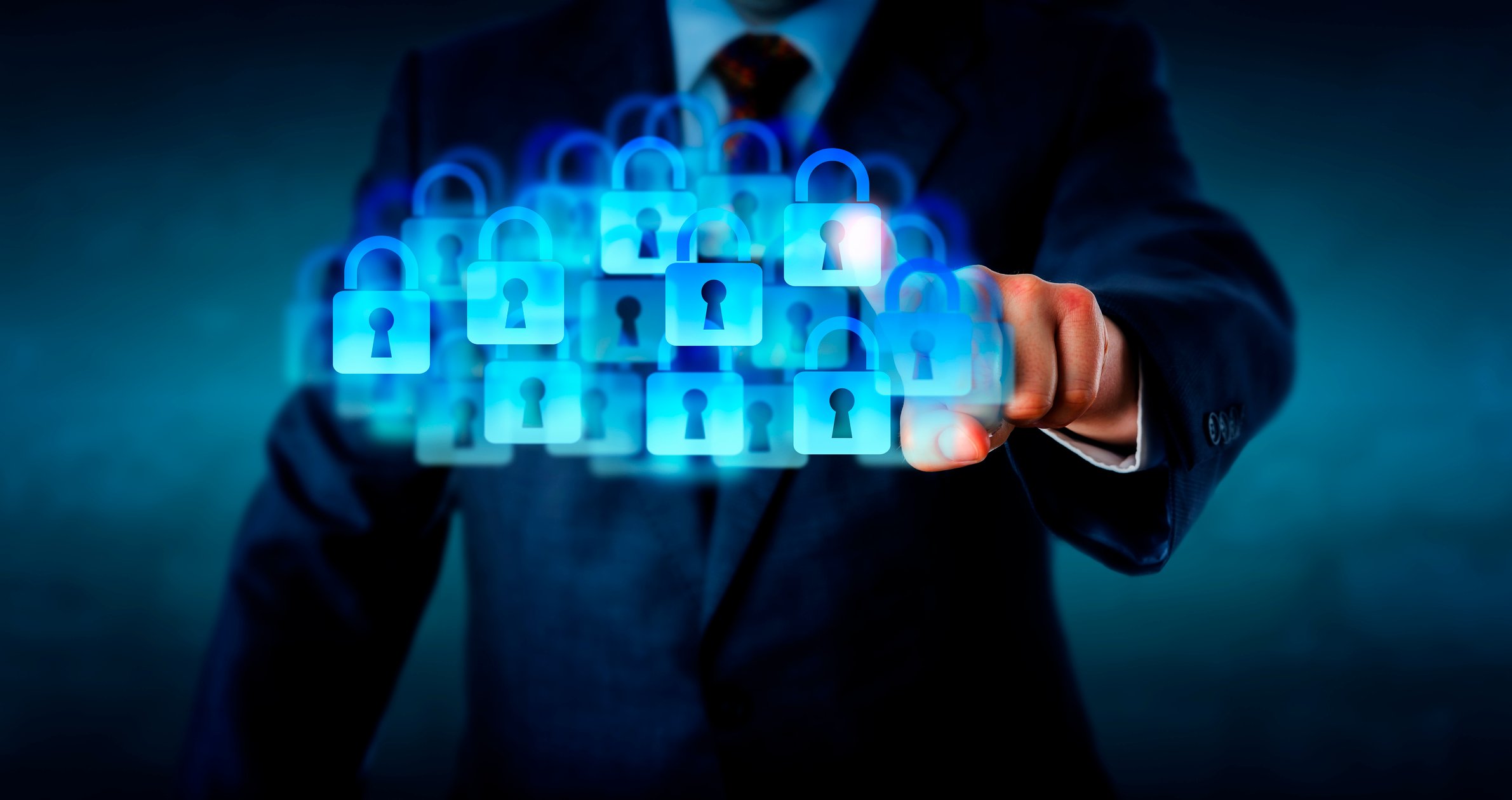 A businessman presses a cloud of digital padlocks.