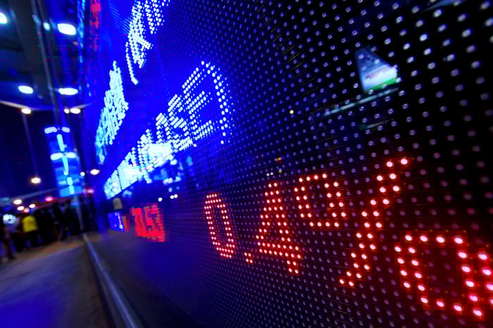 Wall Street electronic trading board at night.