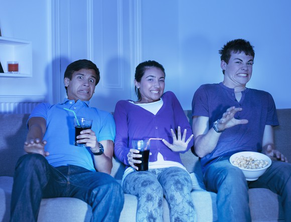 Several teens stream content from the sofa at home.