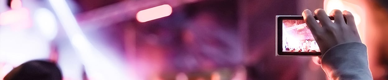 Image of a man holding a smartphone.