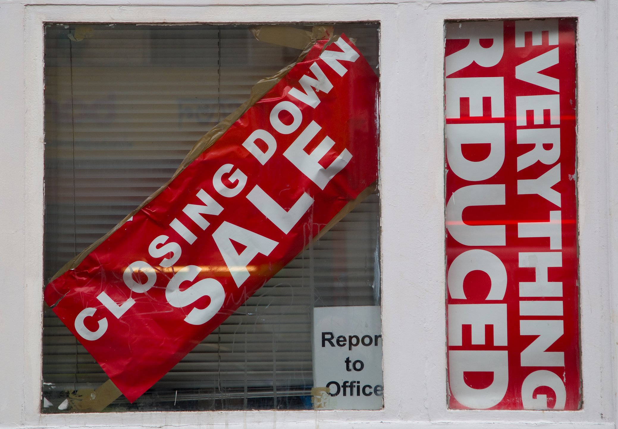A store window with going-out-of business signs