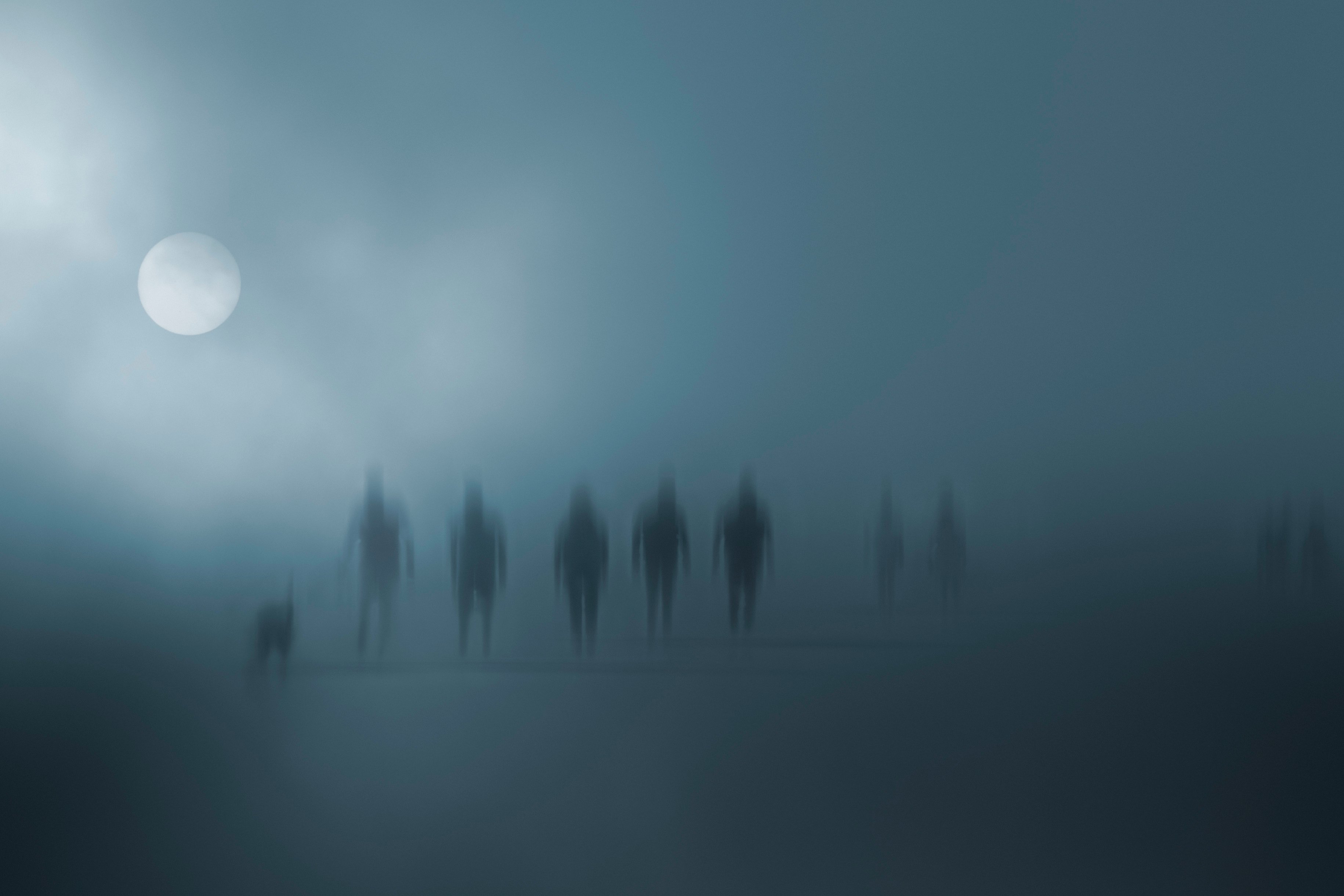 Mysterious blurred people walking in the fog.