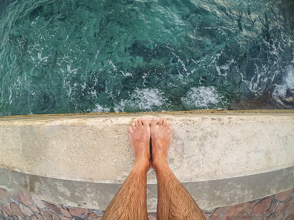 Feet at the edge of a cliff.