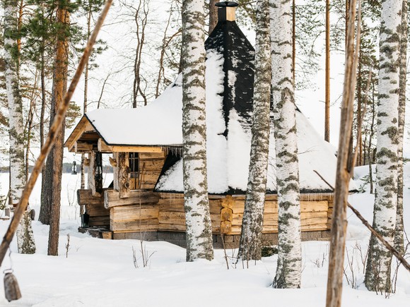 A snow-covered cabin in the woods 
