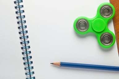 rsz_green_fidget_spinner_on_notepad