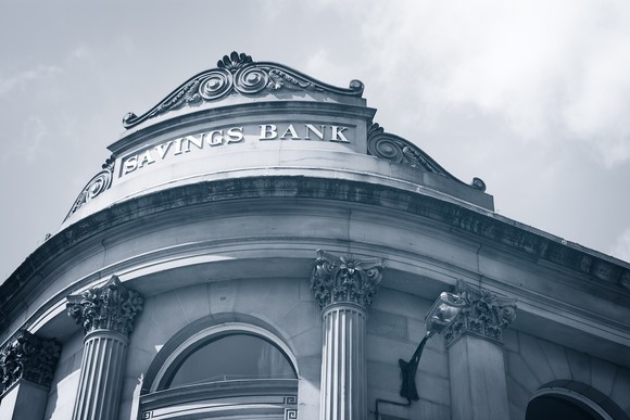 The front of a building that says Savings Bank at the top.