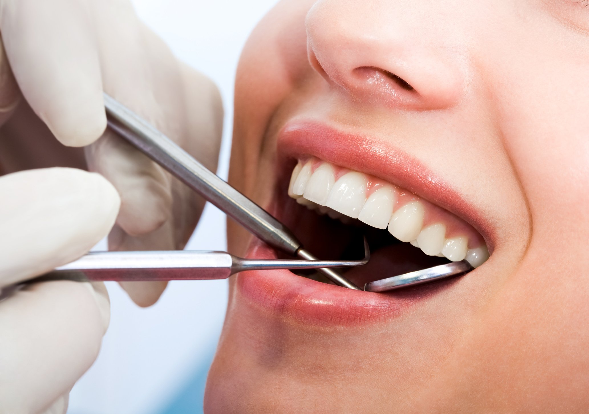 Smiling woman undergoing dental exam