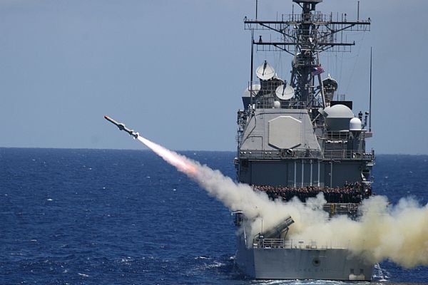 Harpoon missile launches from a ship at sea.