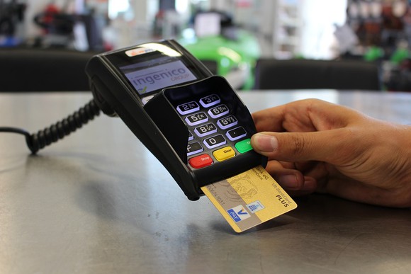 Merchant inserting EMV-chip credit card for payment.