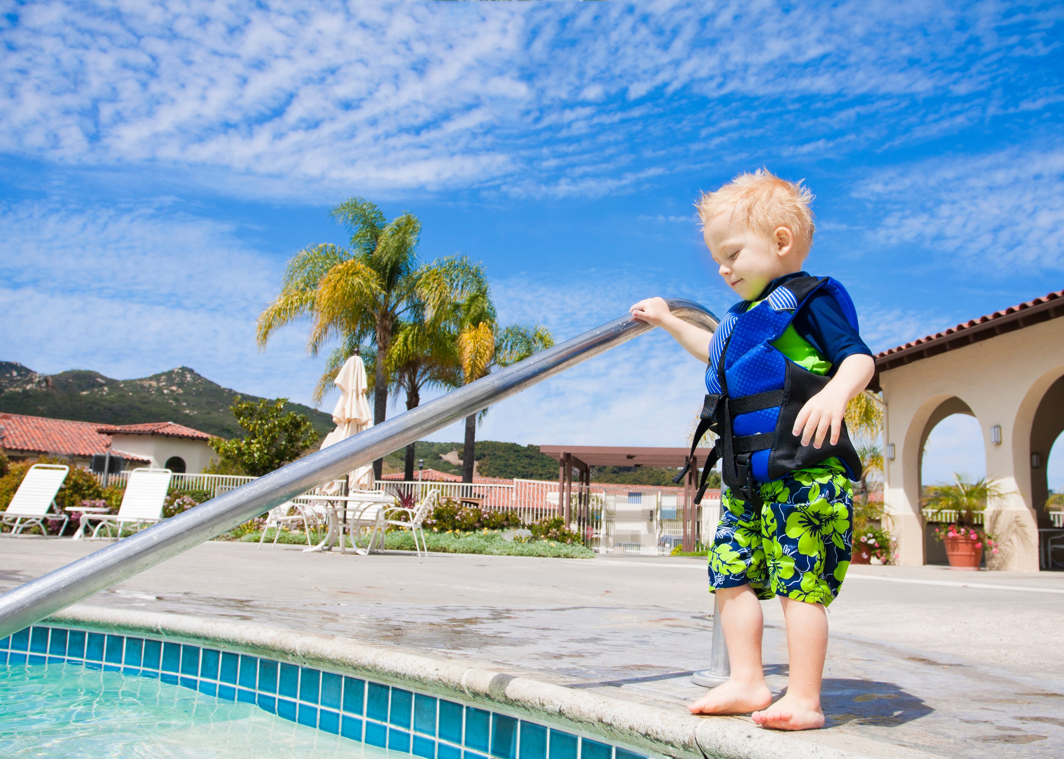 A child stands at the edge of a pool.