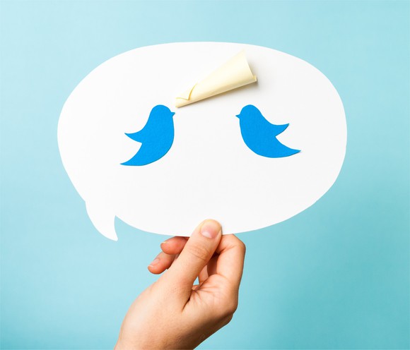 A speech bubble with two Twitter bluebirds tweeting.