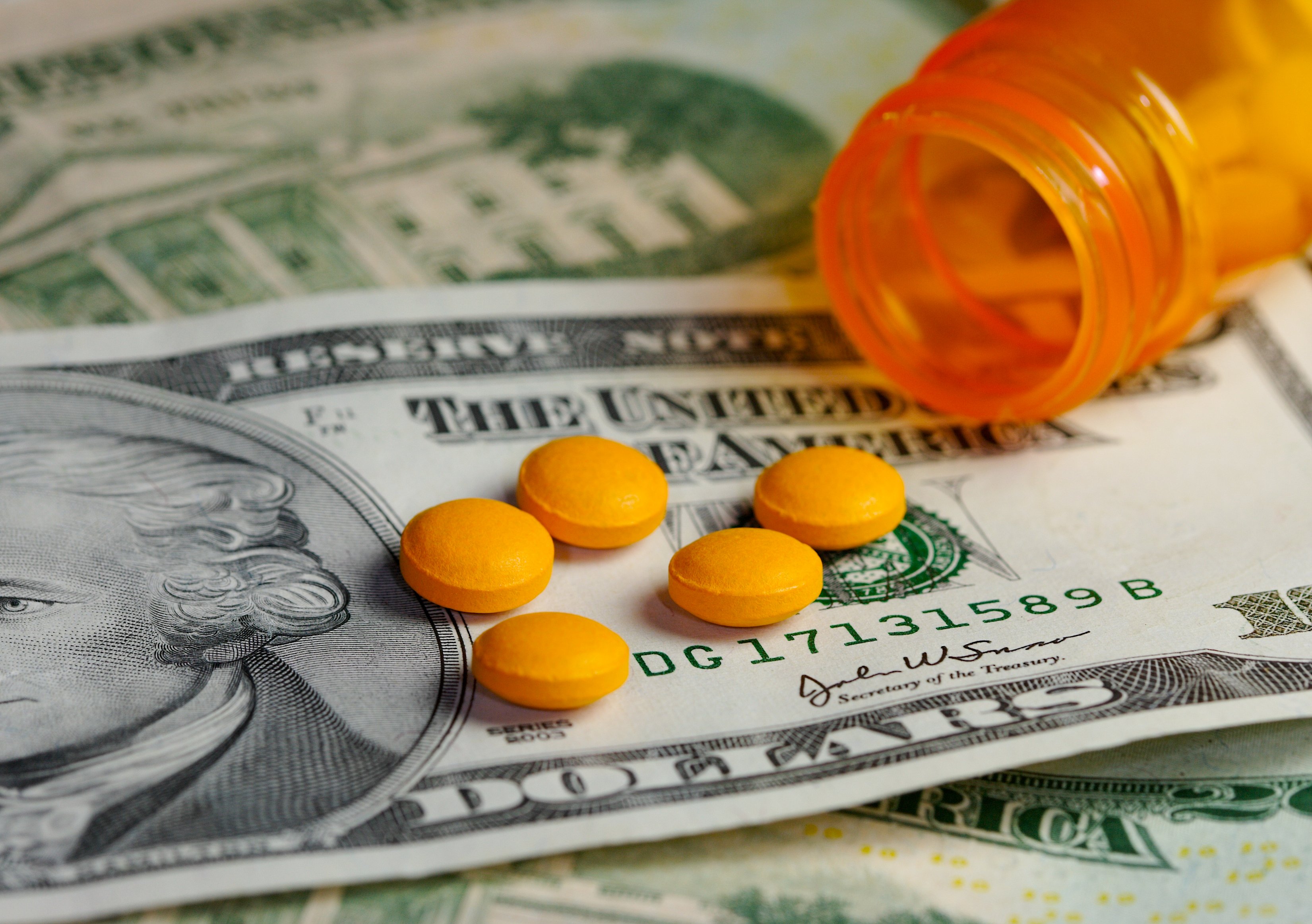 Generic pills on top of money.