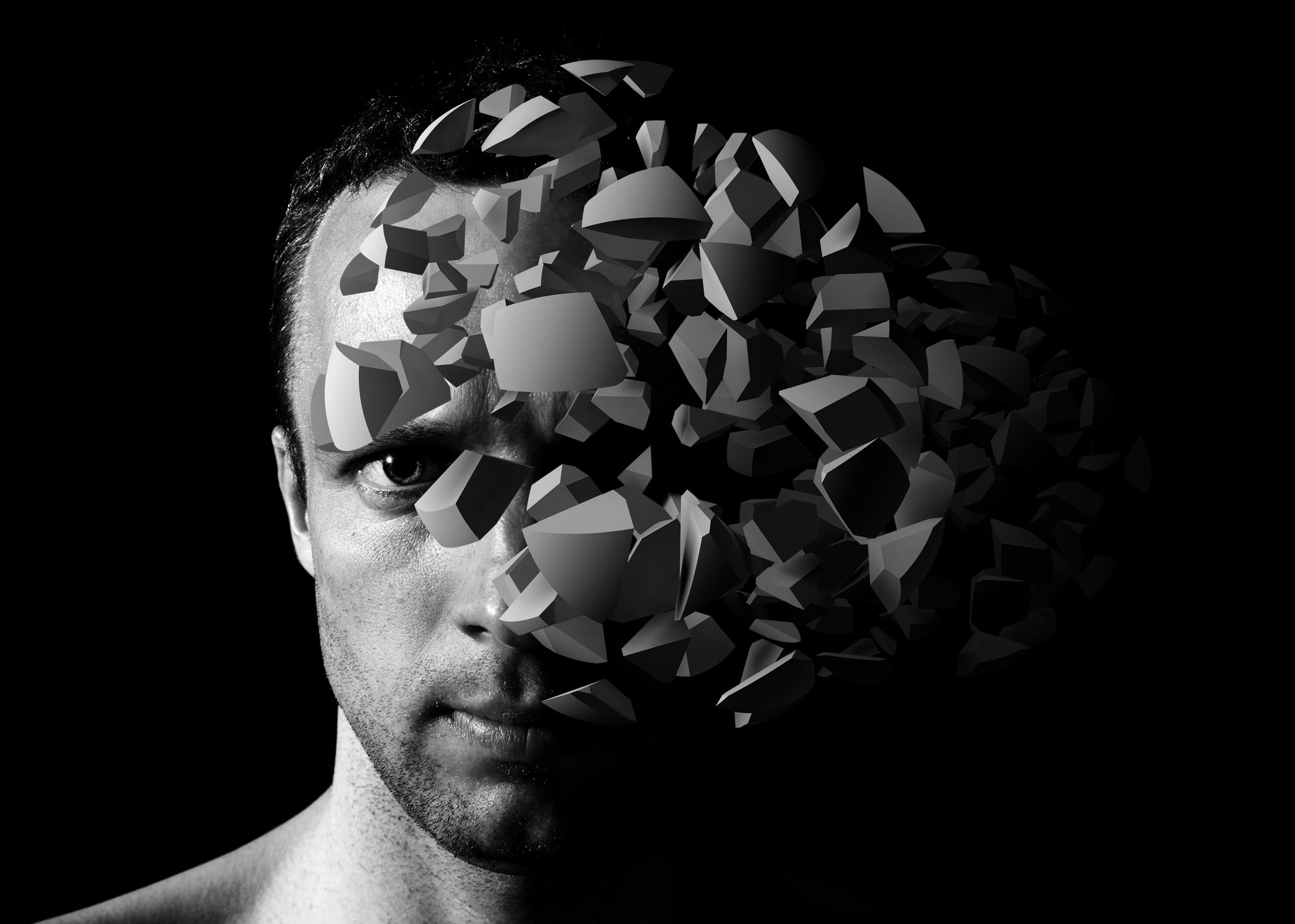 A man with fragments of an object in front of his face.