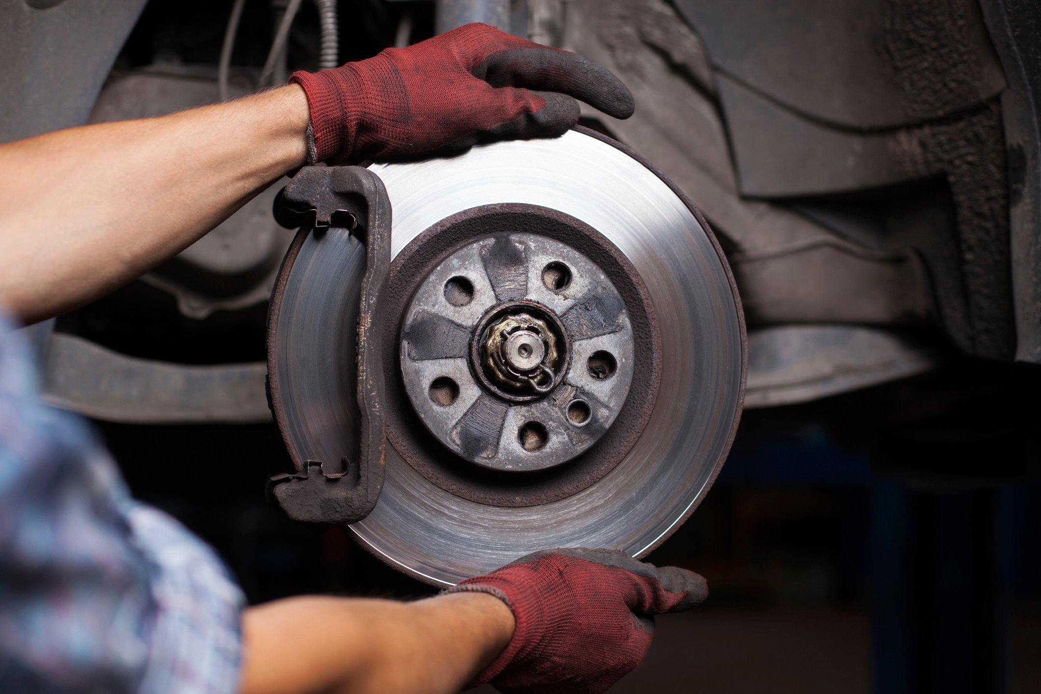 Mechanic fixing brakes on a car