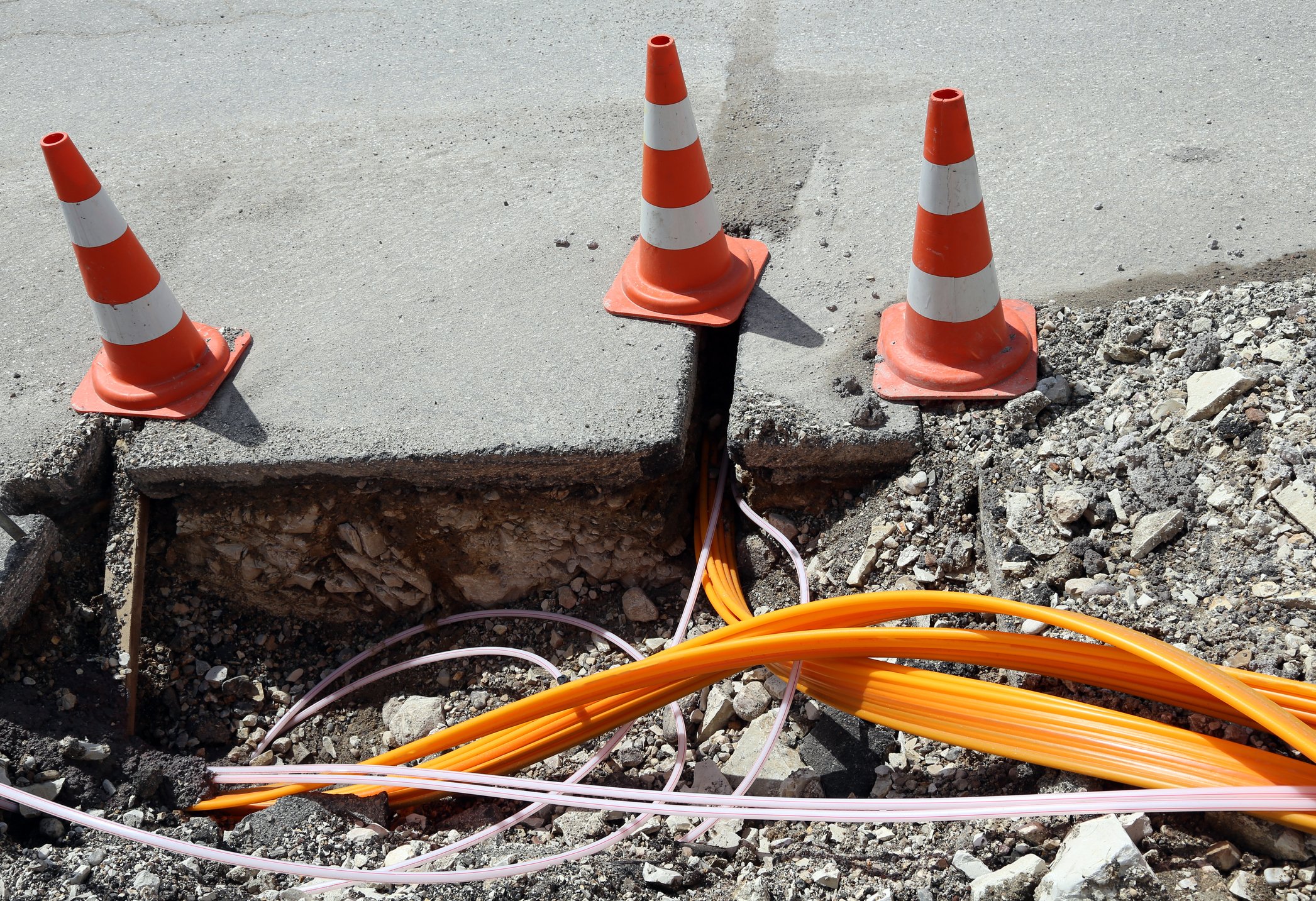 Fiberoptic cables being laid in the ground. 