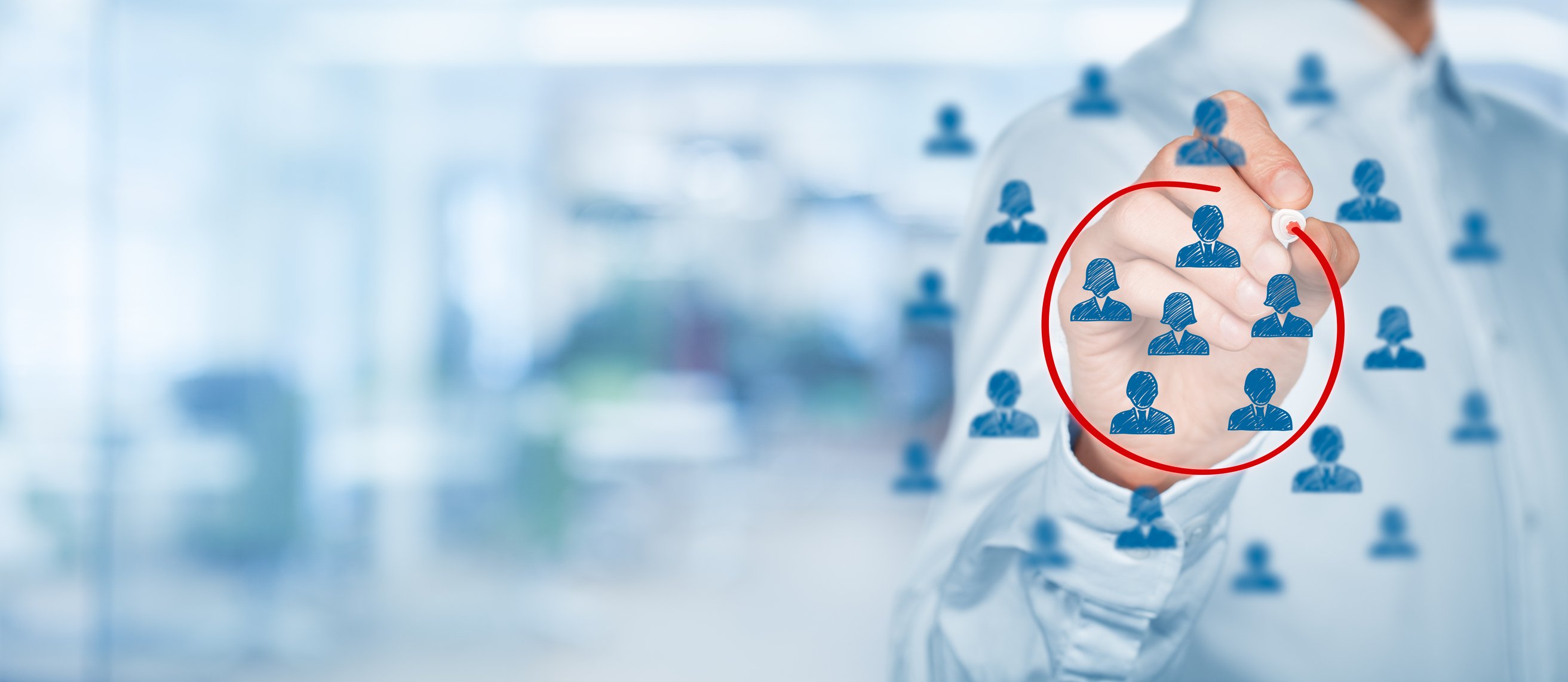 A man circles a group of people on an illustration.