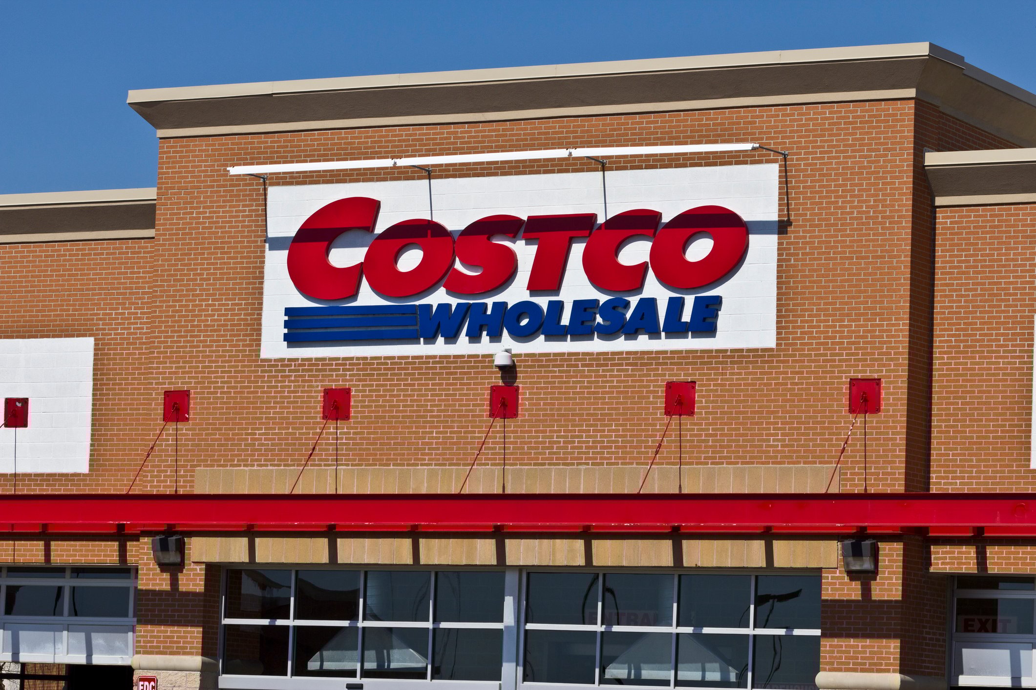 Costco Wholesale sign at the top of a brick building facade.