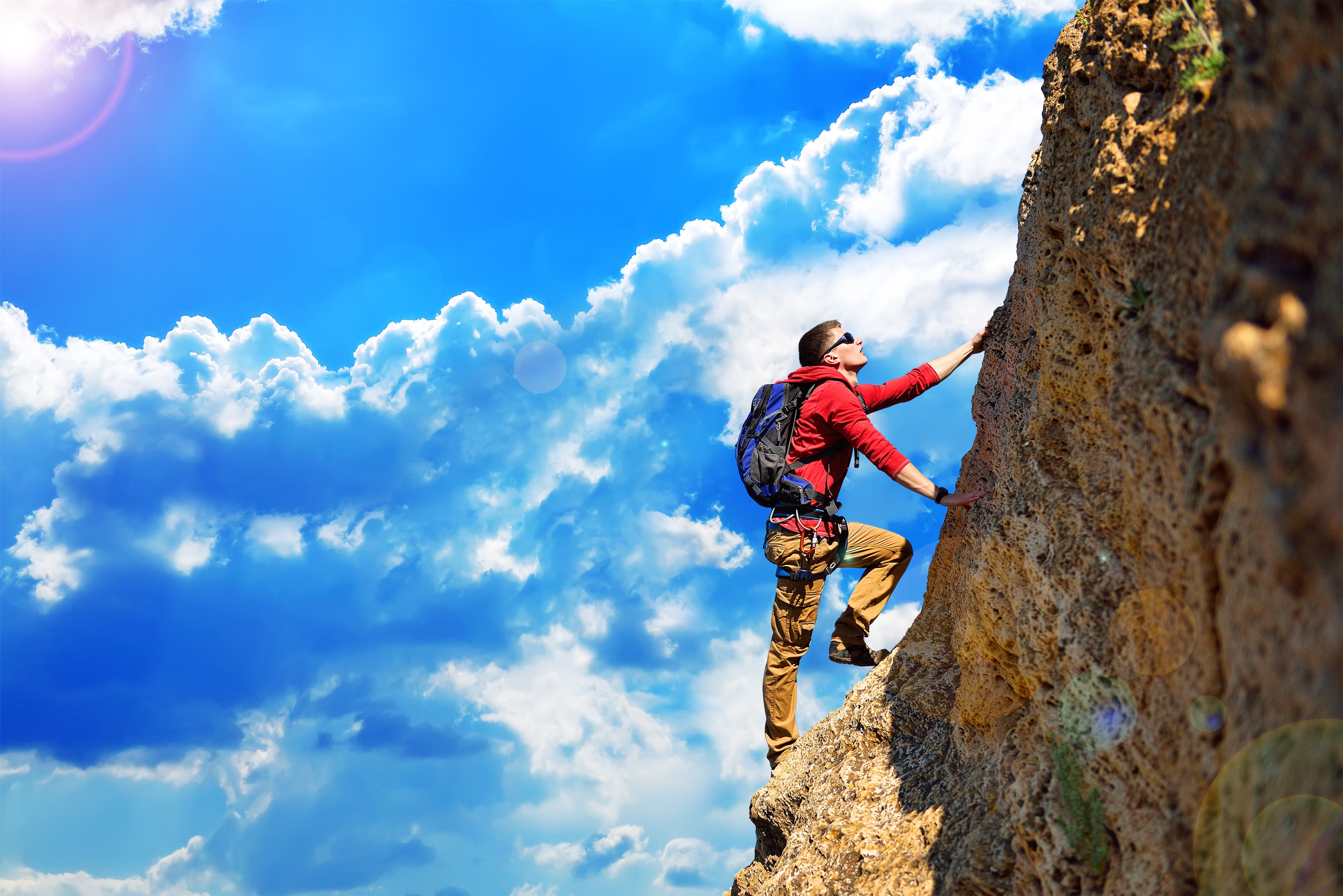 Mountain climber scaling a rock face.