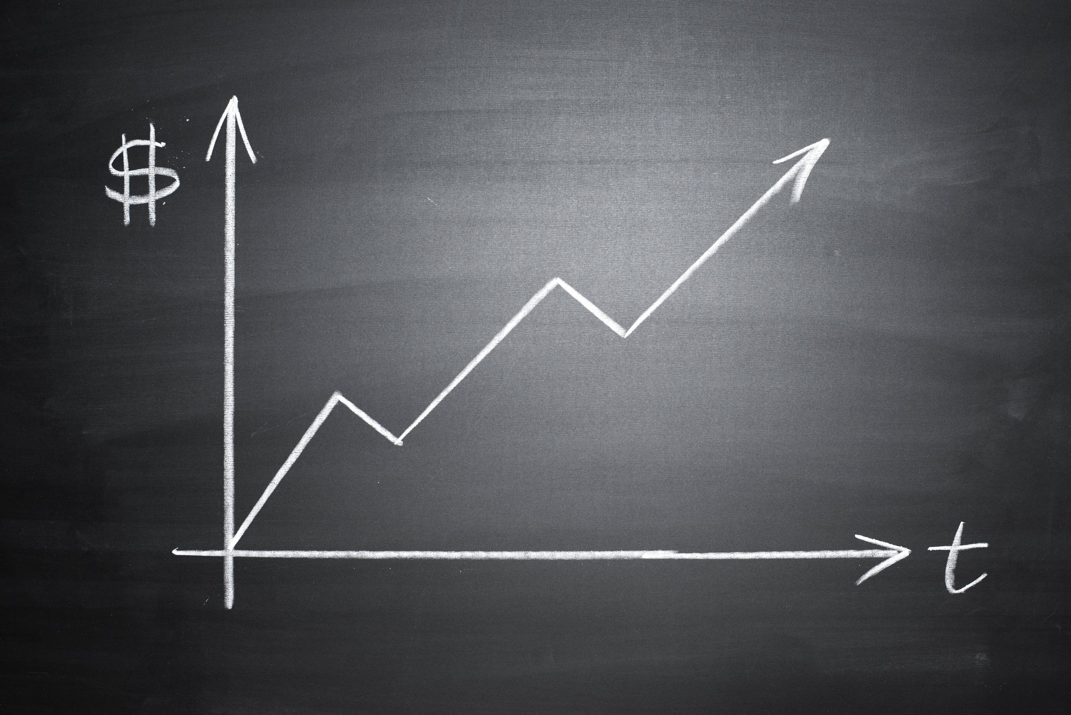 A graph showing an upward trend is drawn on a blackboard. 