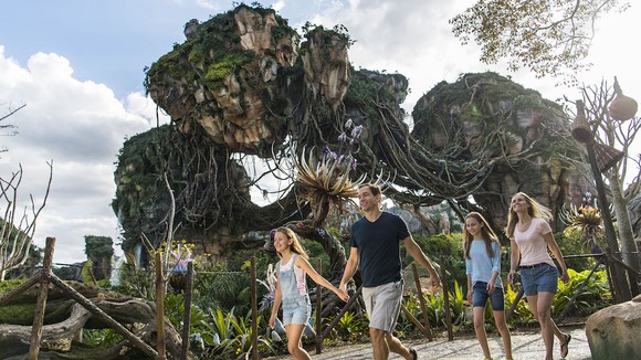 Disney World's Pandora with a family walking in front of the floating mountain.