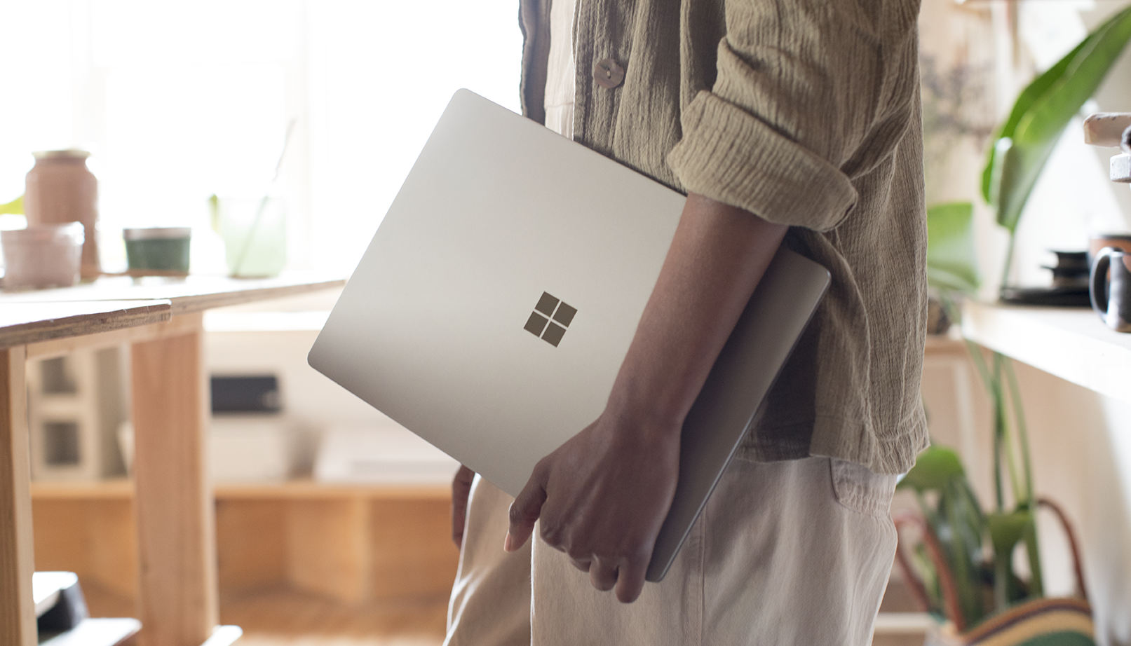 Man holding a Surface laptop.