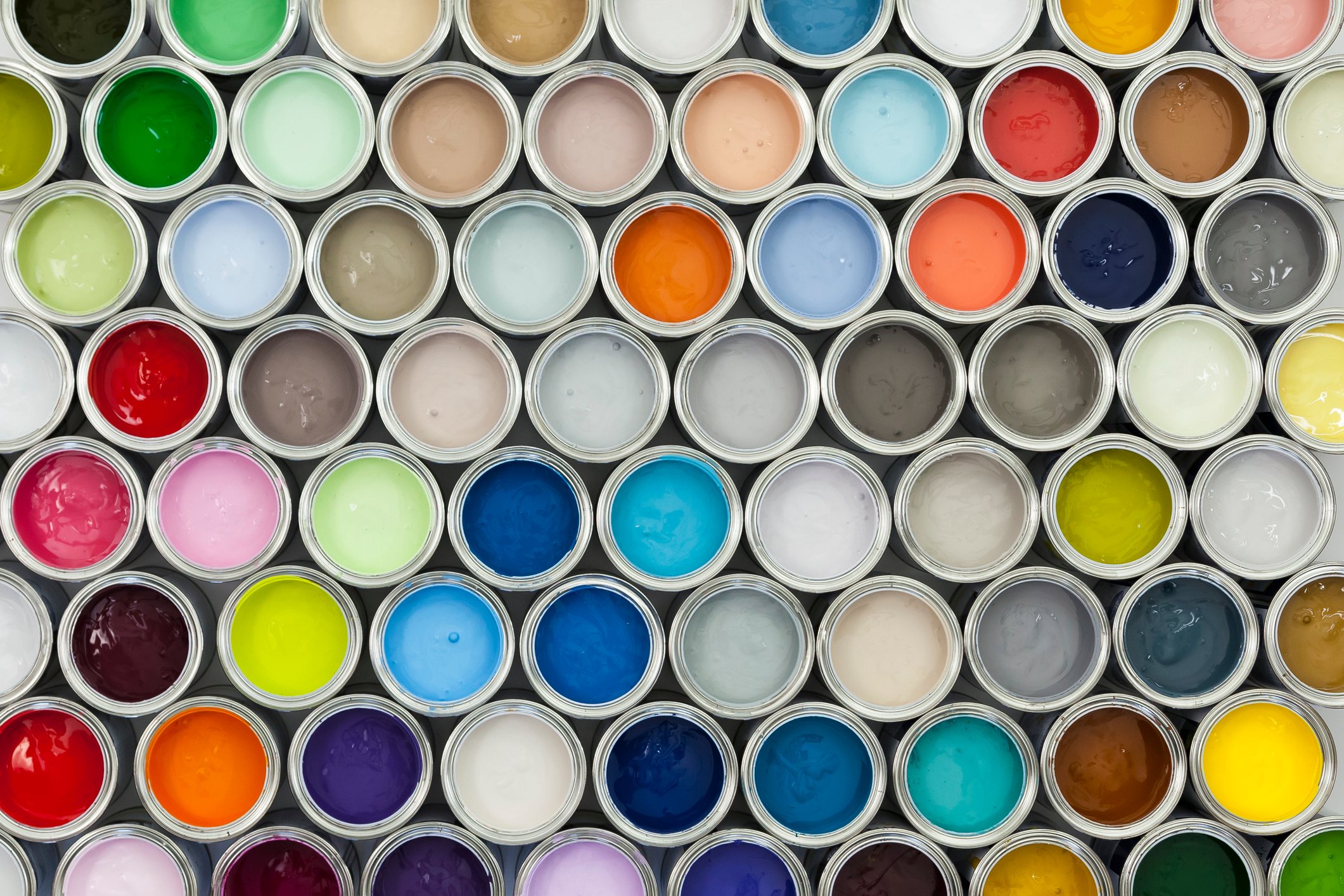 A selection of open paint cans viewed from directly above.