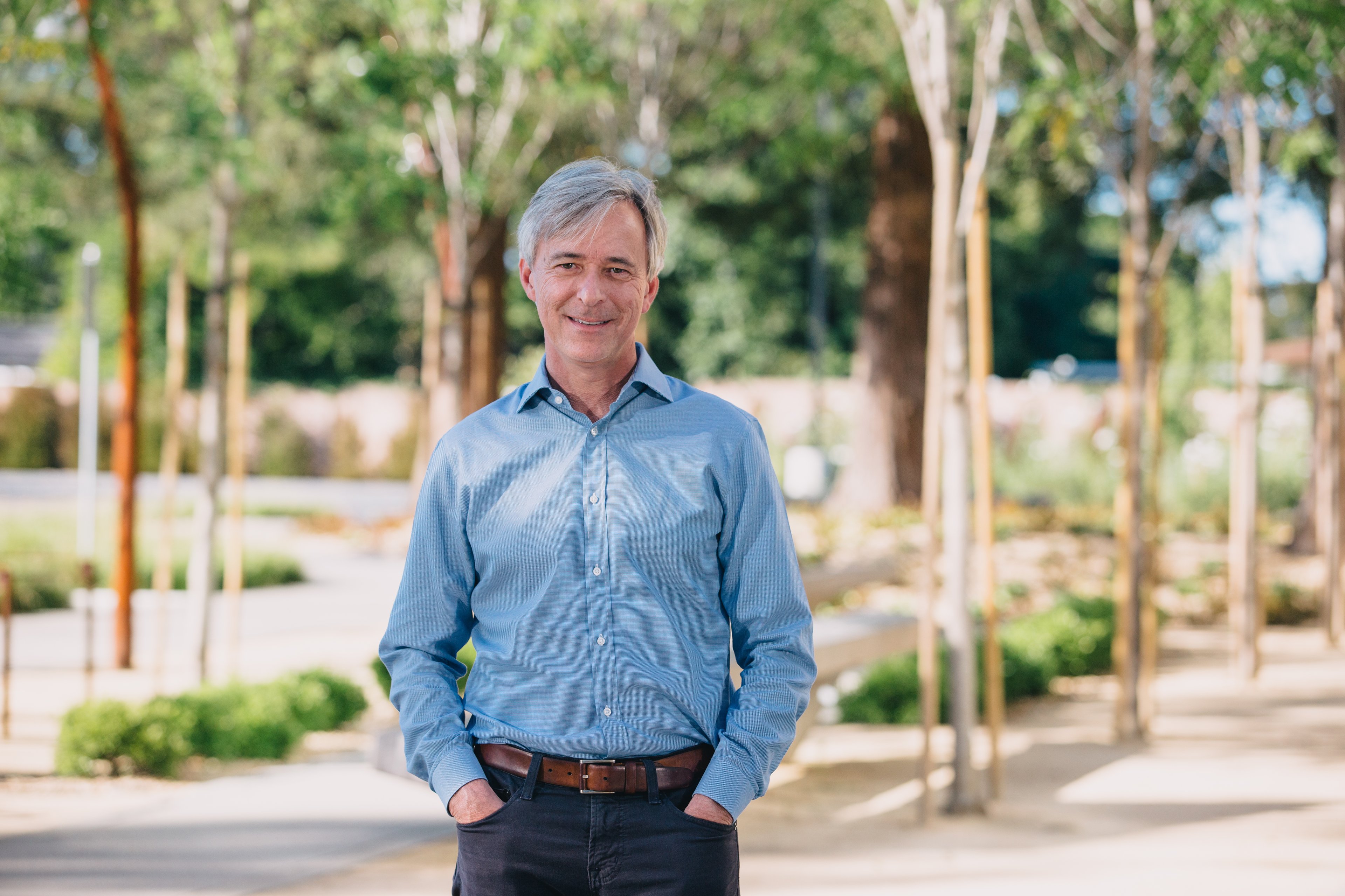 John Krafcik, standing in a sunny parking lot.