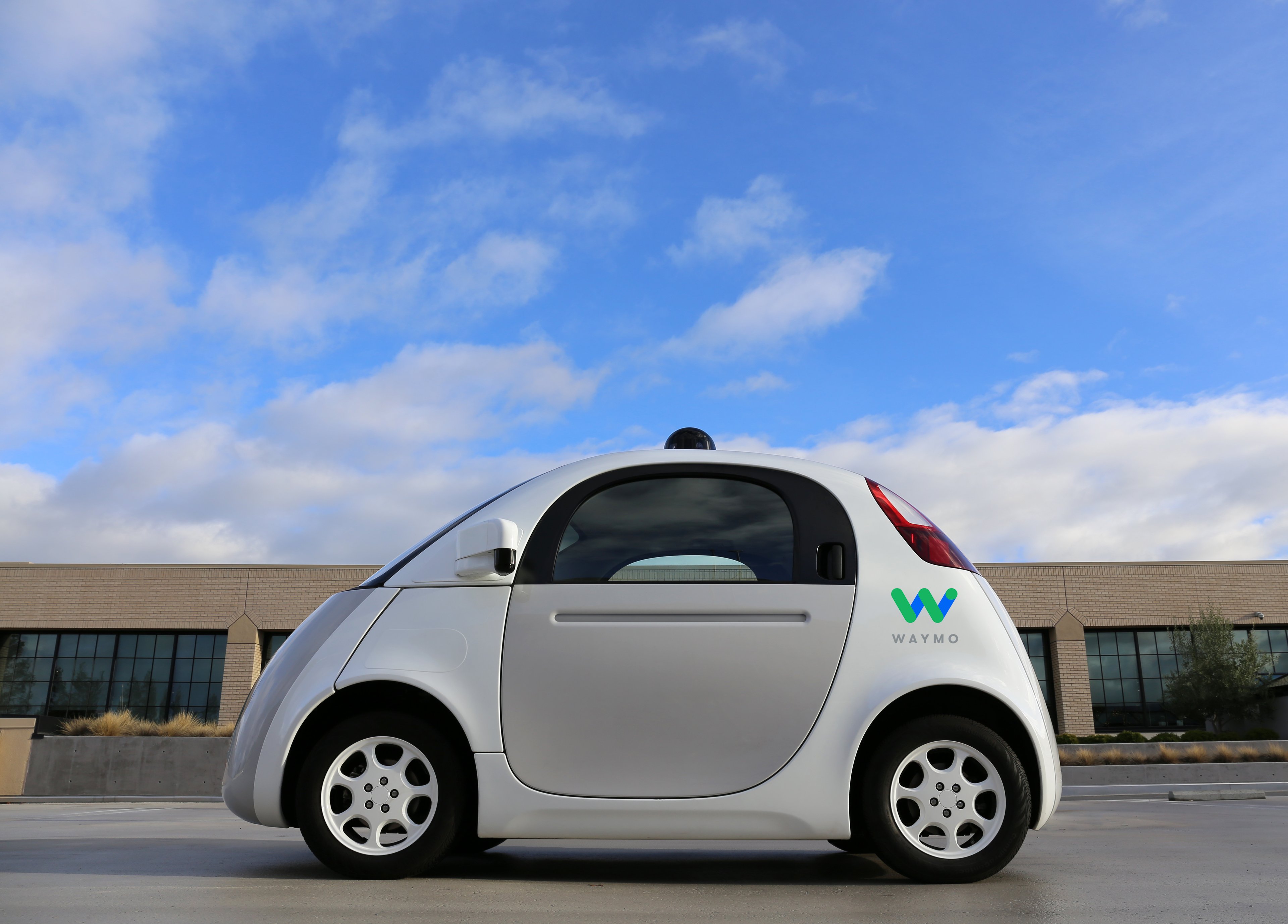 A "panda" test car with a Waymo logo.