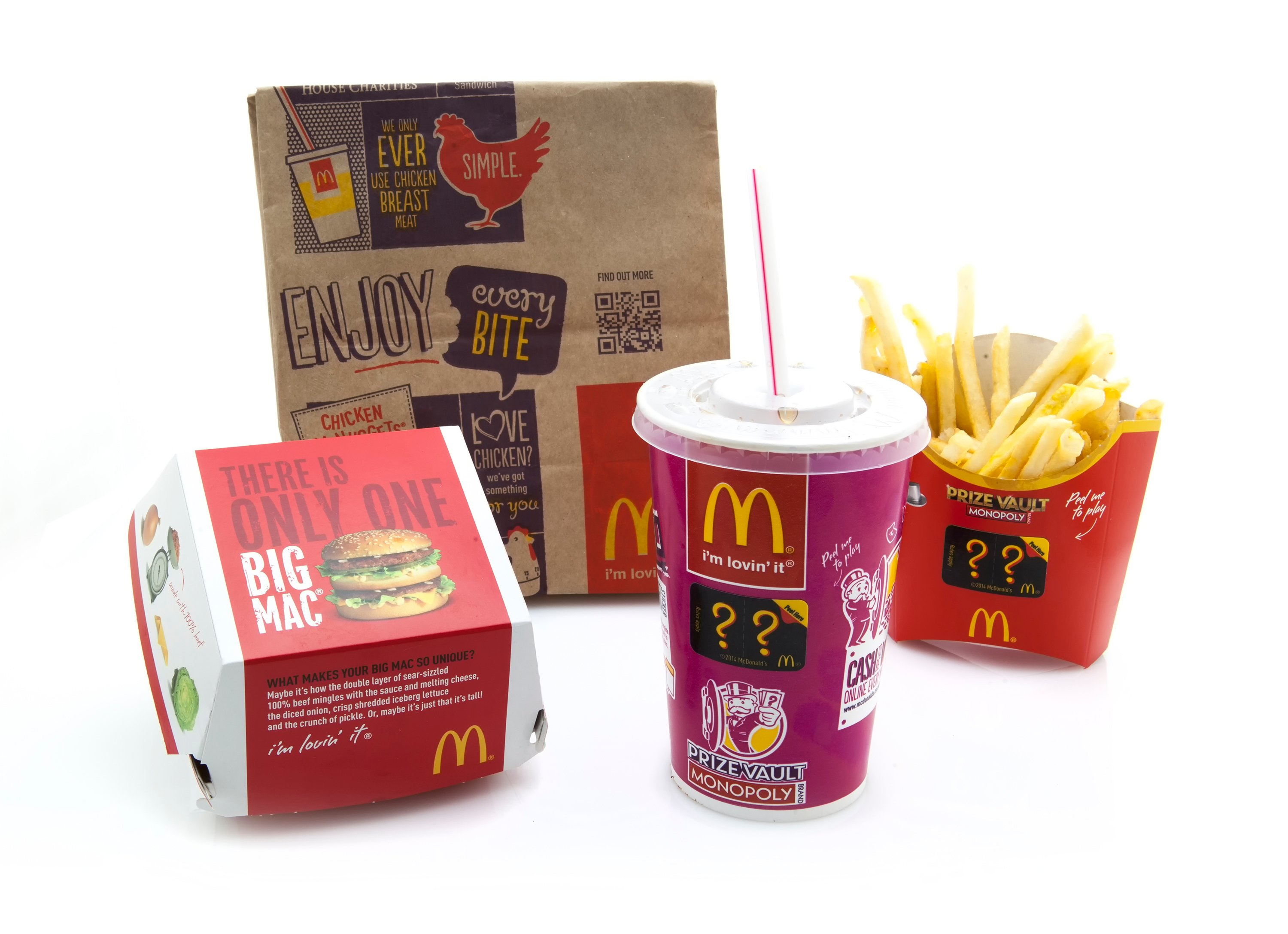 A McDonald's bag, hamburger container, fries, and soft drink.