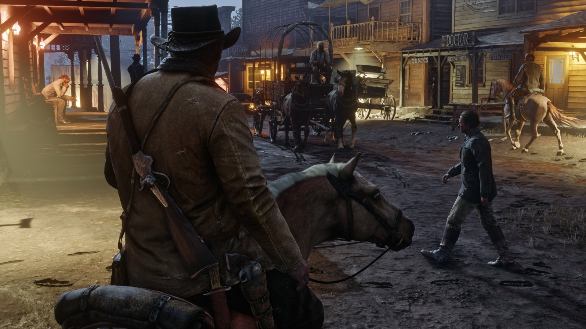Screenshot of in game scene from Red Dead Redemption 2 depicting a man riding into a western town on horseback at night time.