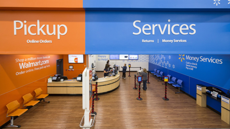 Inside a Wal-Mart store, the services area is displayed. On the left is where you pick up online orders. On the right is the returns and money services area.