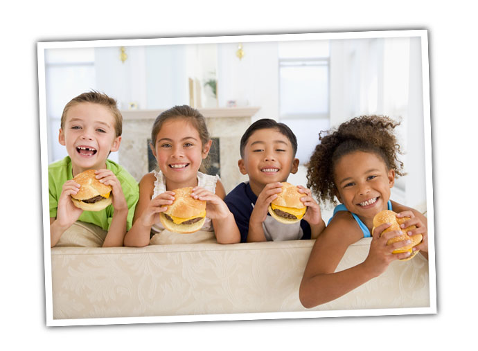 Kids eating cheeseburgers.