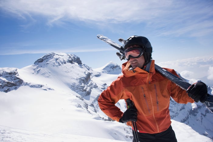 A man carrying skis.