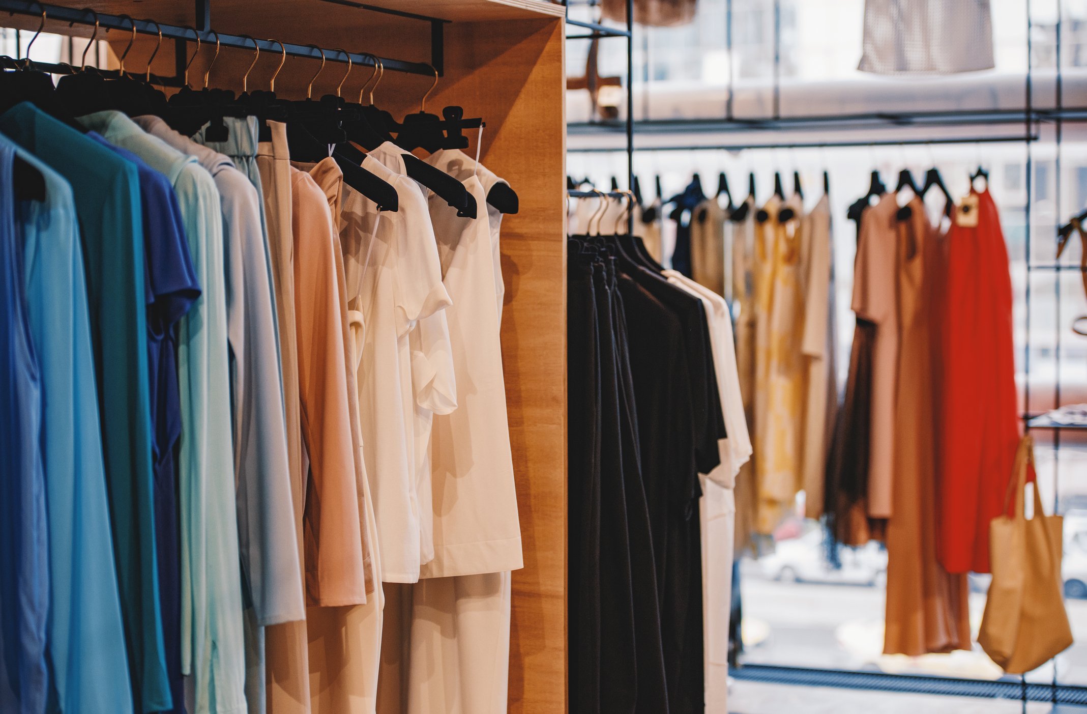 Racks of women's clothing on display in a store