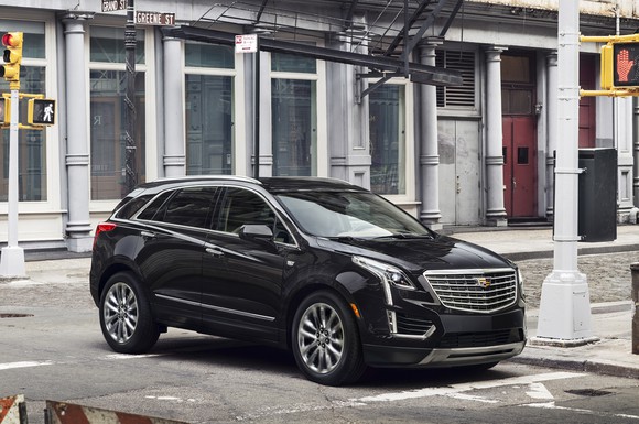 A black Cadillac XT5 crossover SUV on a New York City street.