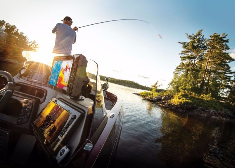 A fisherman casts from his boat