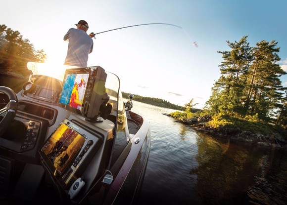 A fisherman casts from his boat