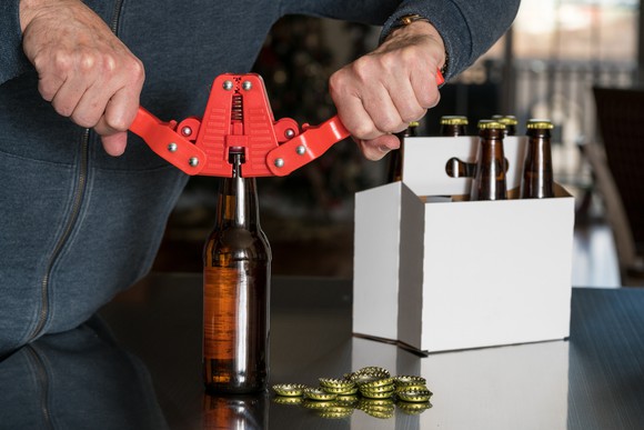 A home brewer caps beer bottles