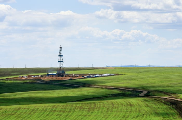 Drilling rig in field.